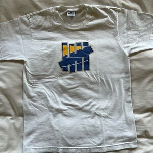 Undefeated White Tee with blue/yellow 5-strikes logo